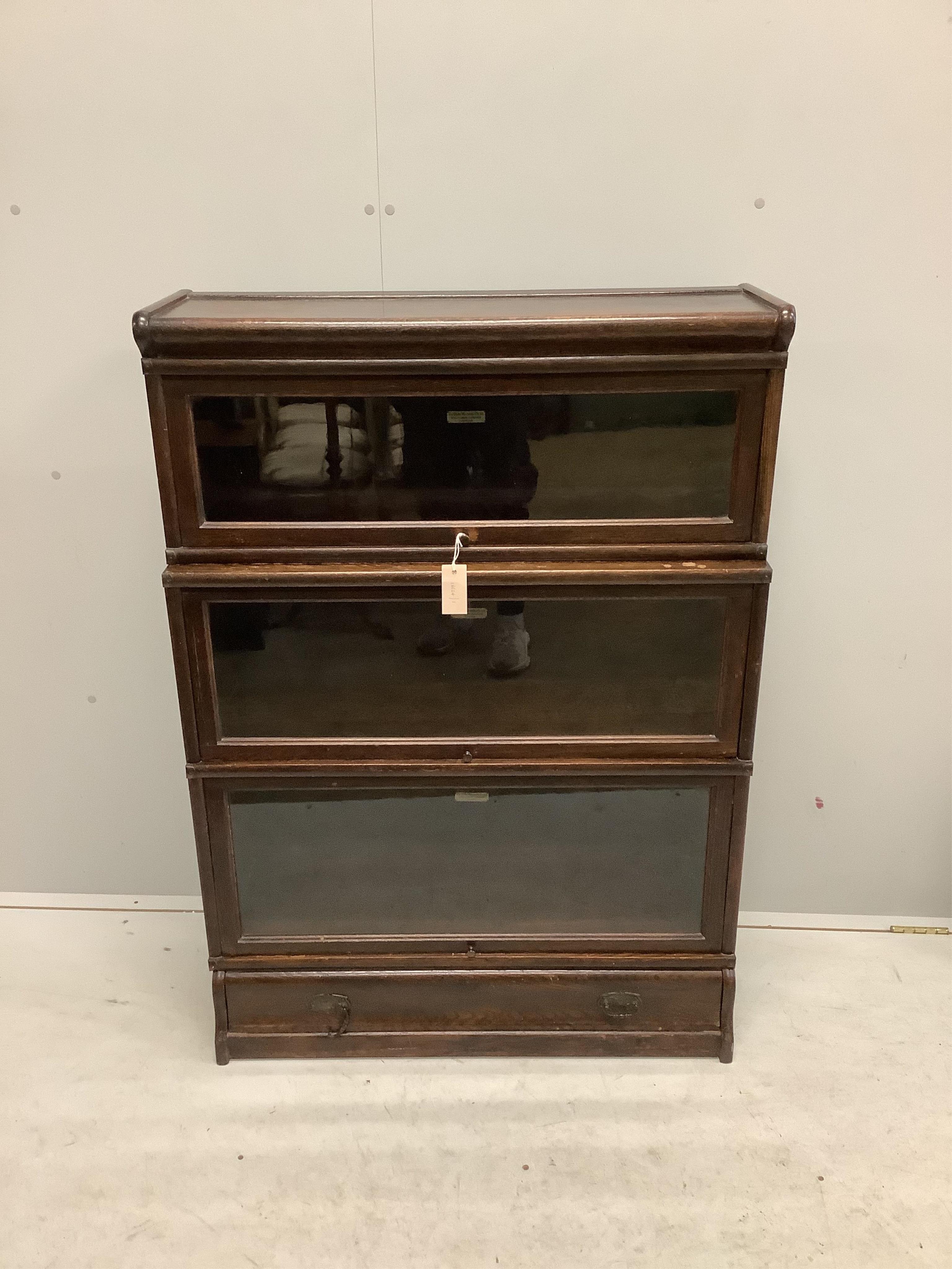 A Globe Wernicke oak three section bookcase, width 86cm, depth 33cm, height 122cm. Condition - fair